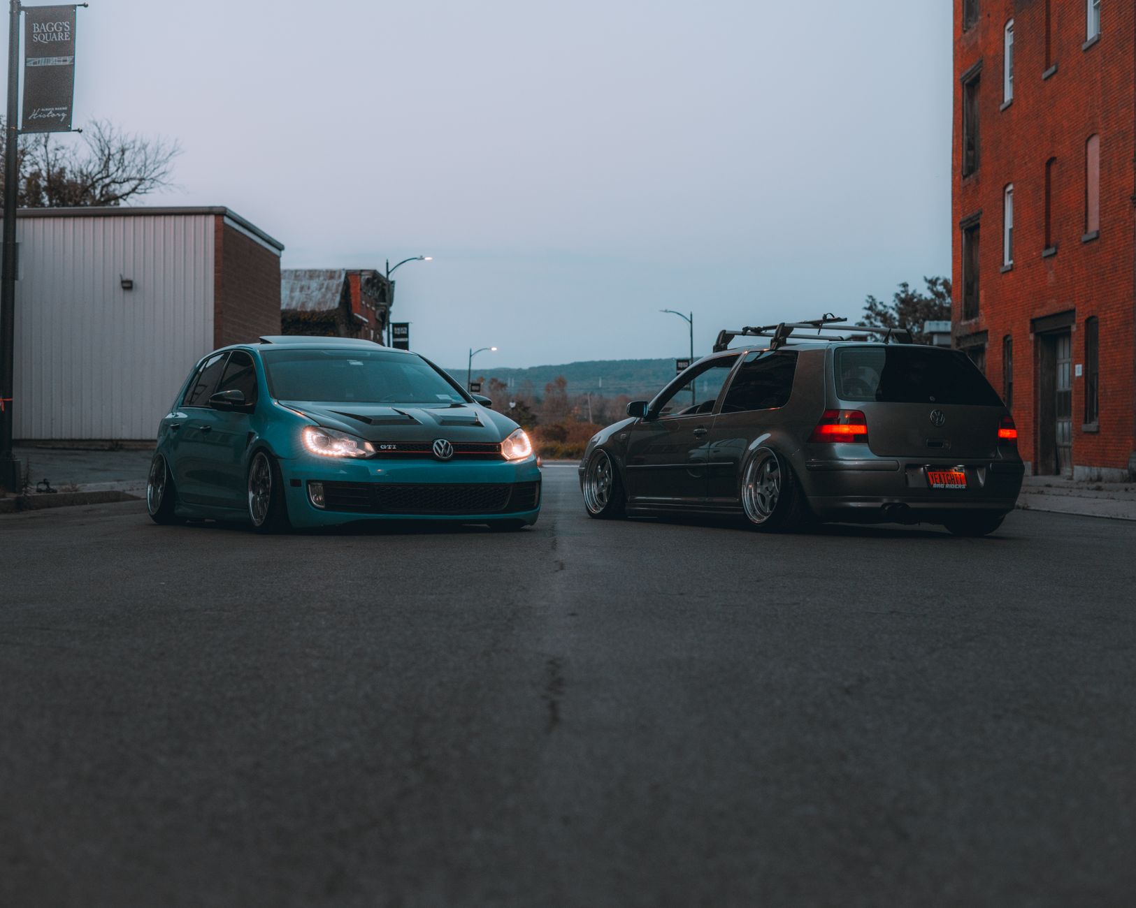 Dwa Volkswageny zaparkowane przy ulicy o zmierzchu w mieście